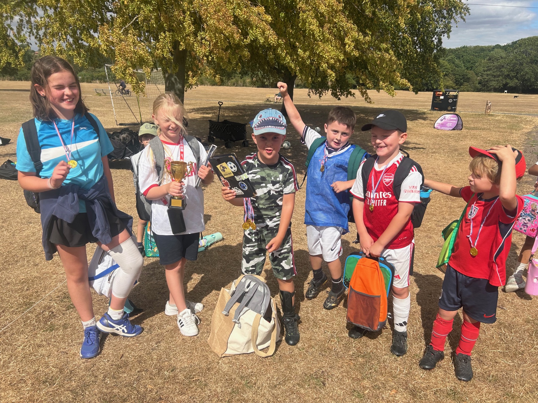 Football Frenzy children smiling with medals and a trophy