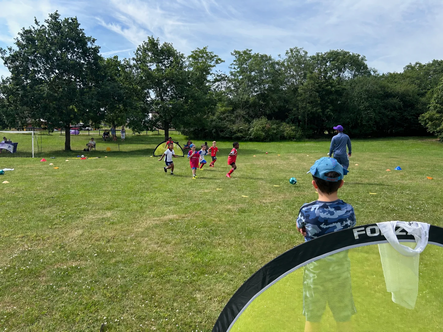 Children playing football with small goals, seen from the touchline
